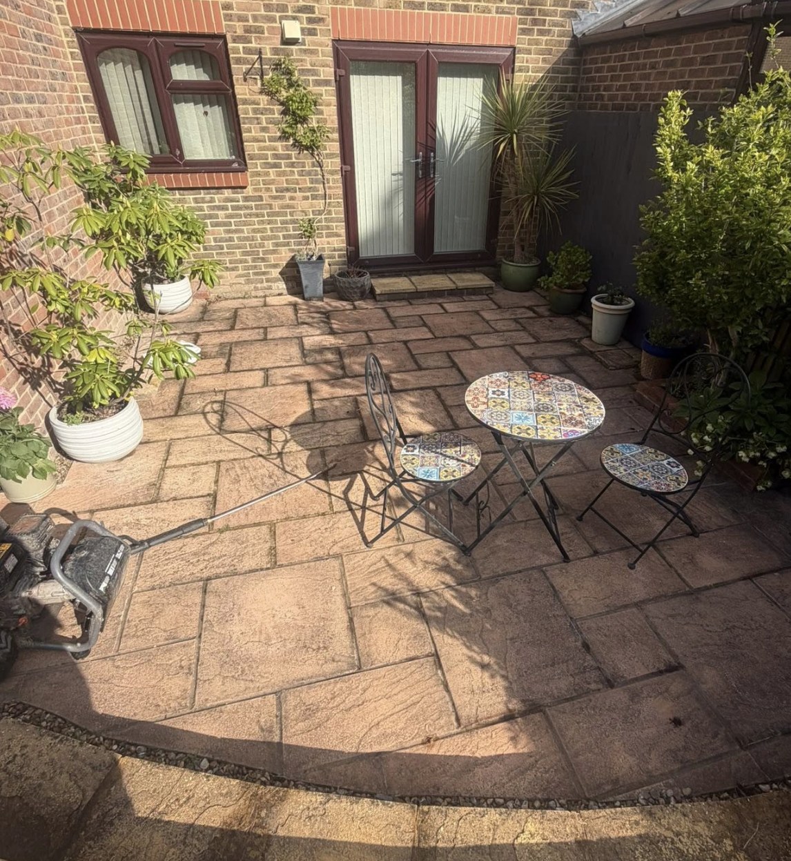 Courtyard patio darkened with algae before cleaning