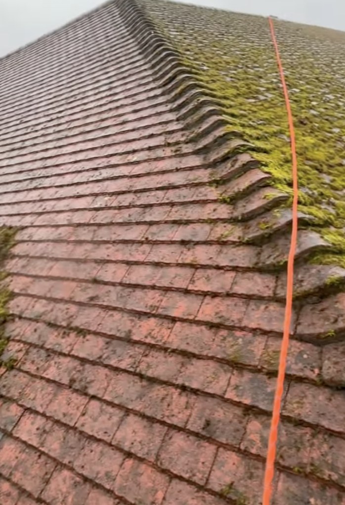 A roof ridge half way through cleaning